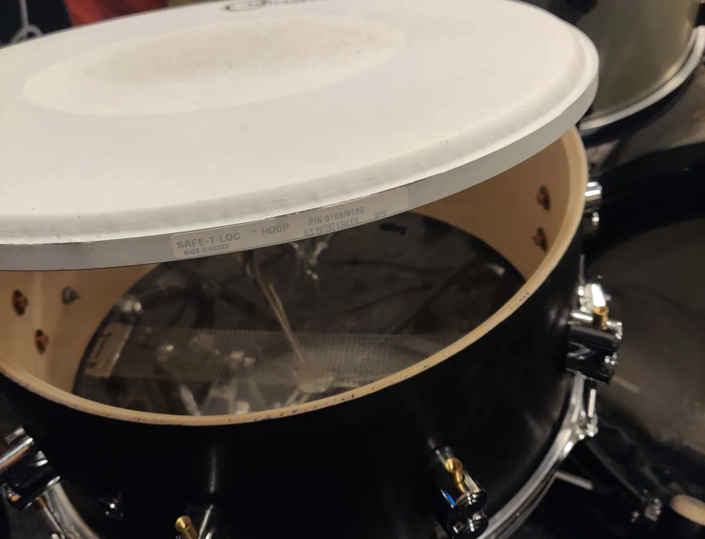 Changing a snare head: the hoop and old head lifted off the shell
