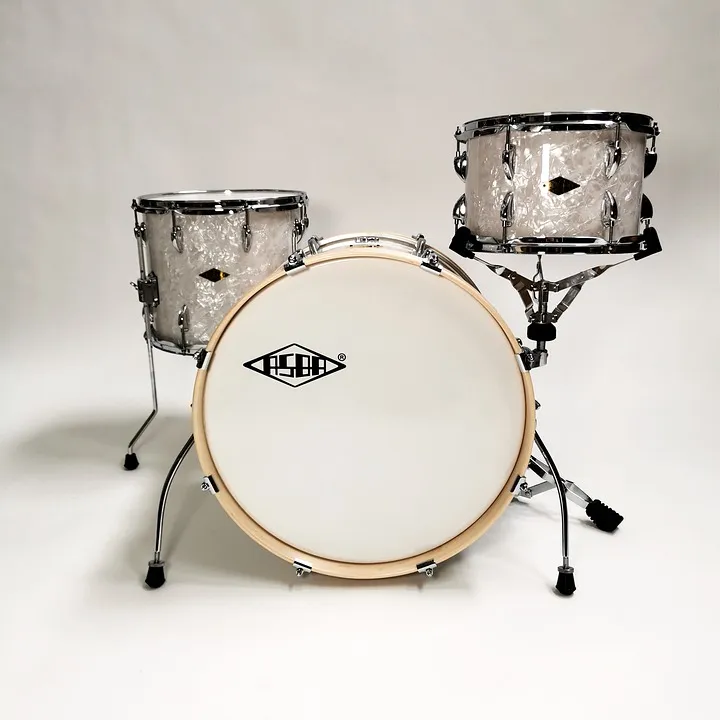 Three-piece drum kit with the bass drum's white front head visible in front