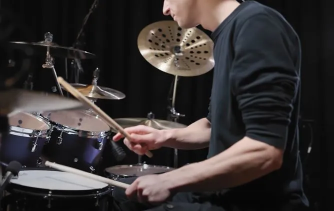Drummer playing the hi-hat with the right hand above the snare, hi-hat at a good height