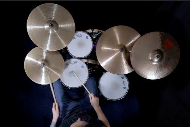 Drum kit from above: cymbals, snare and toms arranged around the player