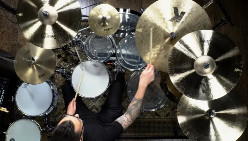 Big drum kit from above: several Zildjian cymbals and toms around the player