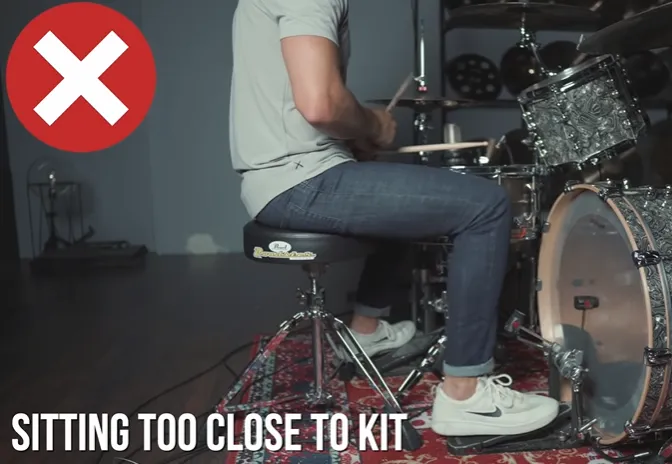 Wrong sitting position: drummer sitting too close to the kit (Sitting too close to kit)
