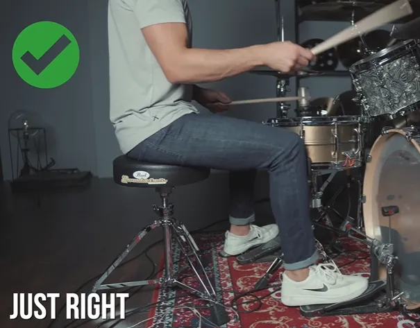 Correct sitting position on the drum throne at a good distance from the pedals (Just right)
