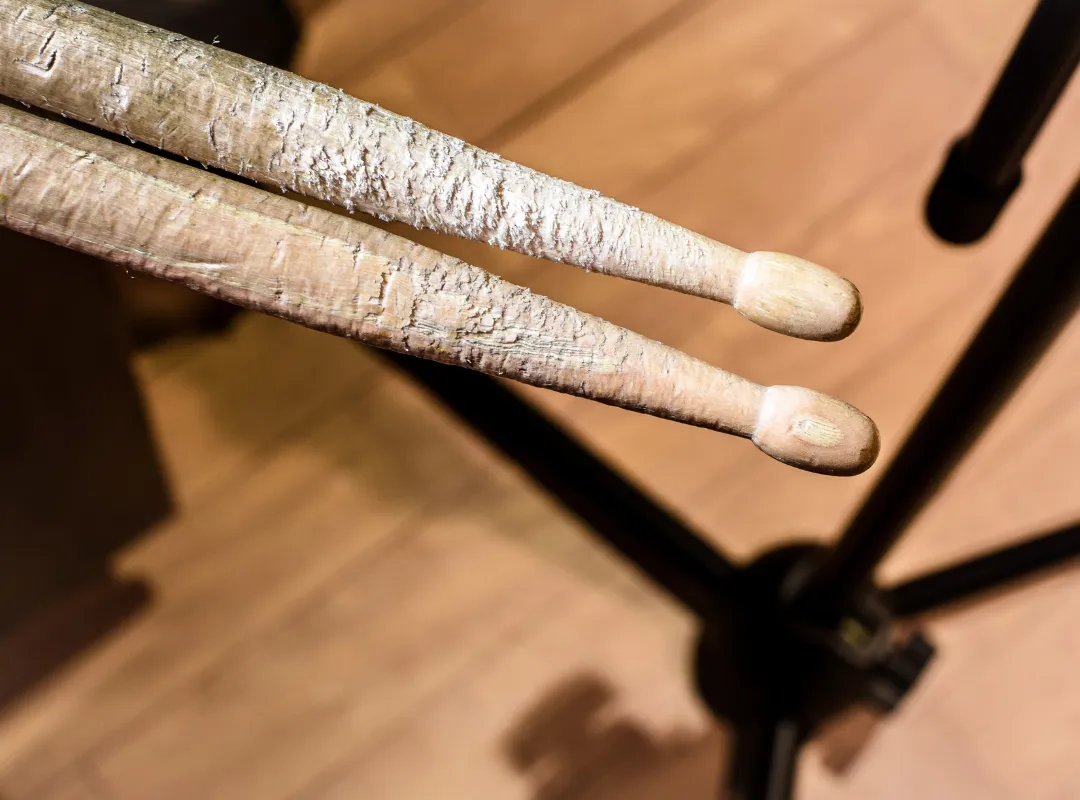 Worn and frayed drumsticks with the tips still intact