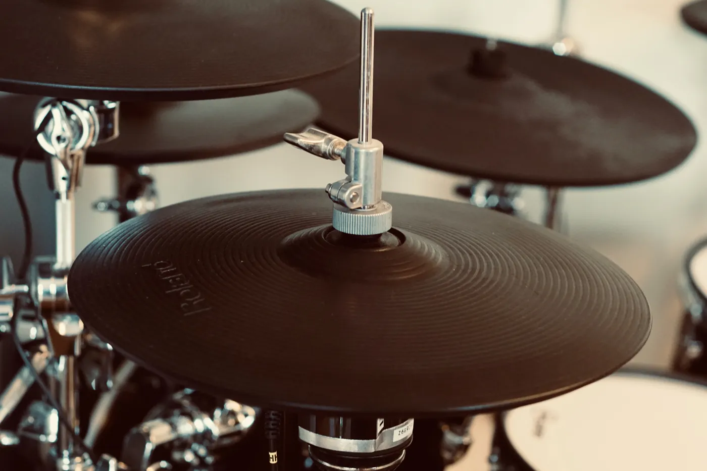 A one-piece rubber-surfaced e-drum hi-hat on a stand