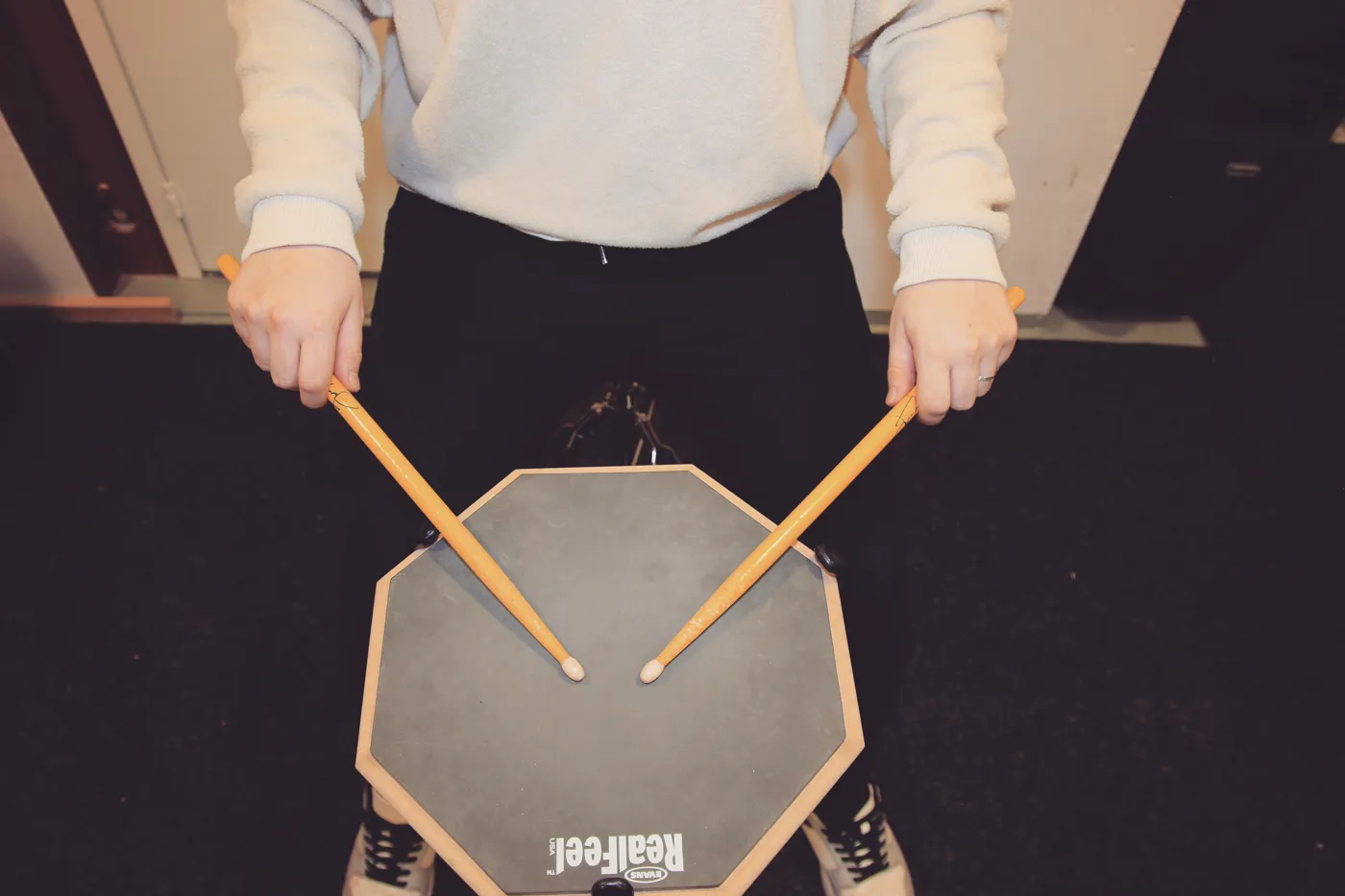 German grip on a practice pad: backs of the hands and knuckles facing up