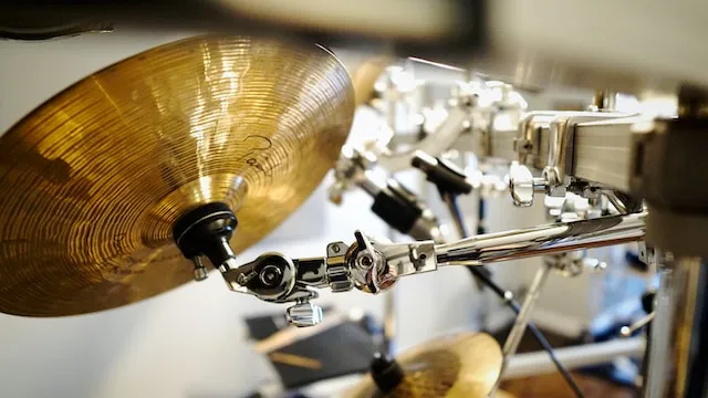 Close-up of a cymbal holder on a boom arm attached to a drum rack
