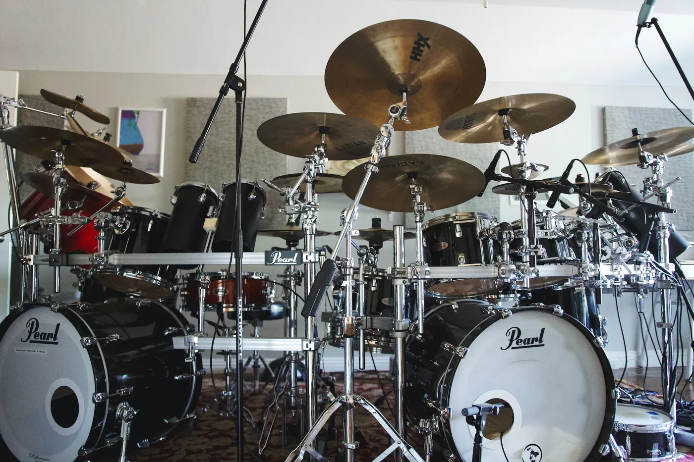 A big Pearl drum kit with two bass drums, with the drums and cymbals attached to a drum rack