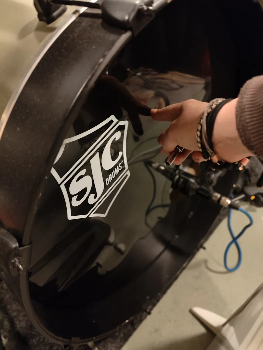 Dampening being placed inside the bass drum through the hole in the front head