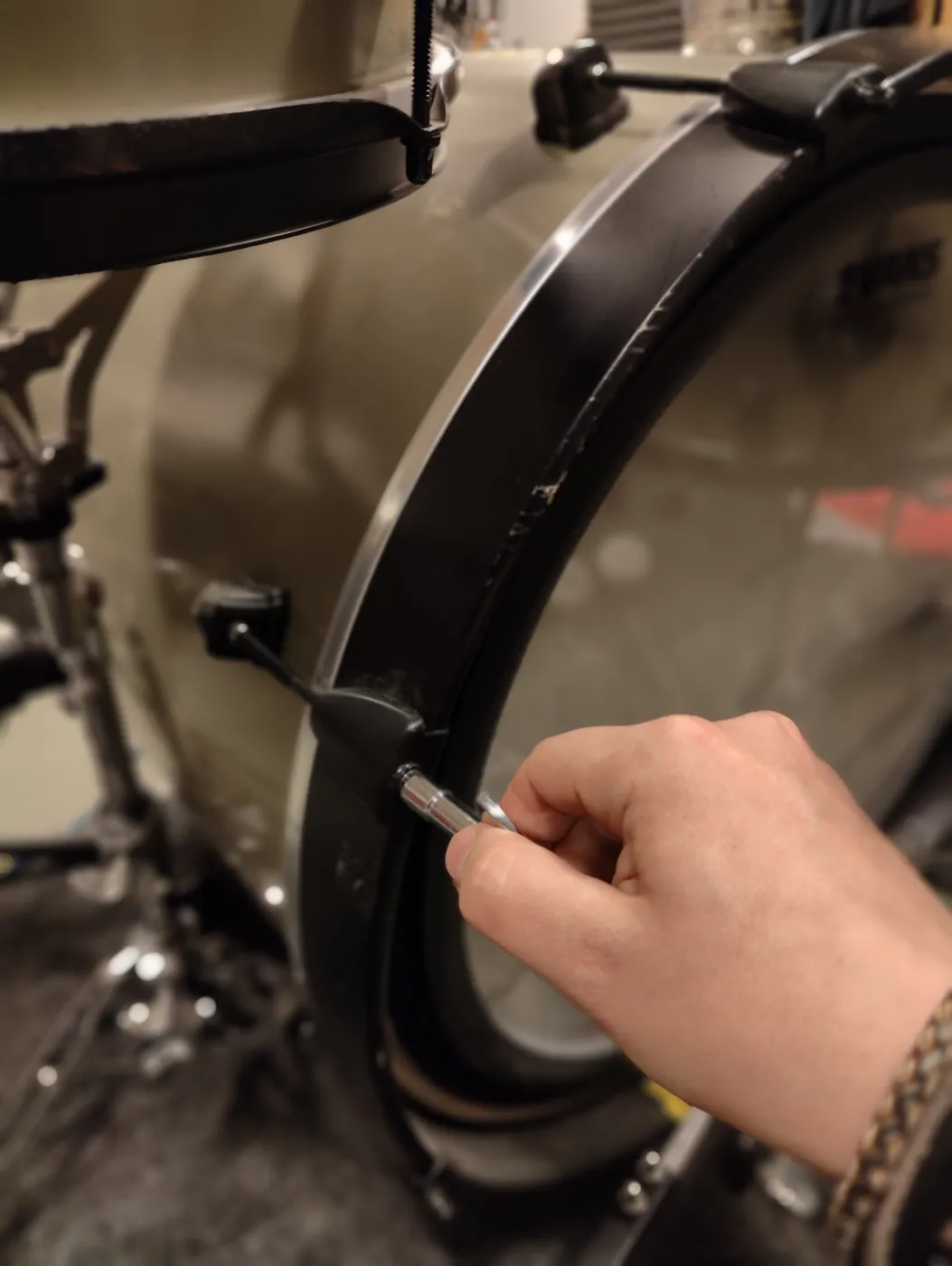 Tuning the bass drum batter head with a drum key