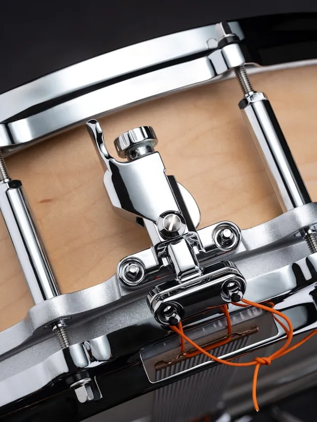 Close-up of the snare strainer's throw-off lever and the snare wire strap
