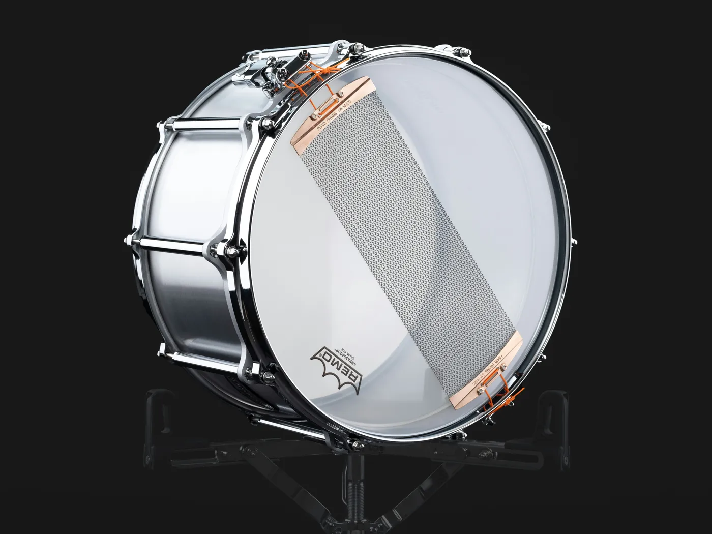 The resonant head and snare wires of a metal snare, with the ends of the wires attached to the strainer