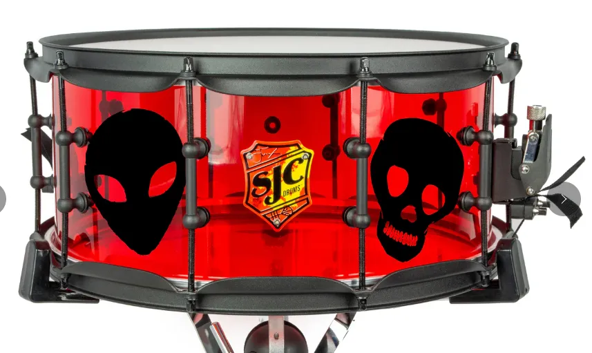A red see-through SJC snare with alien and skull designs