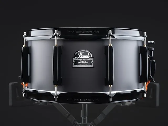 A black Pearl Signature snare on a stand, a standard-depth 14-inch snare