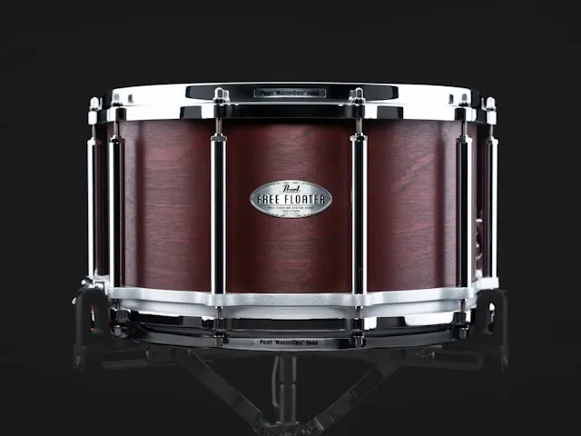 A deep dark red wood-shell Pearl Free Floater snare